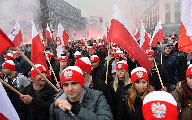 Demonstrators wave Polish flags during annual march commemorating Poland's Independence Day in Warsaw.